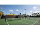 Well-maintained community tennis court with net, fence, and landscaping for an enjoyable game at 31354 Cabana Rye Ave, San Antonio, FL 33576