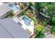 Aerial view of the home, pool, spa, patio, fenced yard, and landscaping at 320 Crosswinds Dr, Palm Harbor, FL 34683