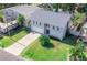 Aerial view of a charming two-story home with a well-maintained lawn and a paved driveway at 320 Crosswinds Dr, Palm Harbor, FL 34683