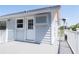 Back porch of the home featuring white railings, a window, and an exterior door at 320 Crosswinds Dr, Palm Harbor, FL 34683