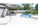 Pool area with stairs, lush plants and foliage, a pergola and a privacy fence at 320 Crosswinds Dr, Palm Harbor, FL 34683