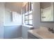 Updated bathroom with marble tile in the shower, window, and sink with cabinet at 320 Crosswinds Dr, Palm Harbor, FL 34683
