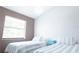 Bedroom with two twin beds with a window, white walls, and wood-style flooring at 320 Crosswinds Dr, Palm Harbor, FL 34683