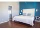 Bedroom with white headboard, side tables, and a door to the bathroom at 320 Crosswinds Dr, Palm Harbor, FL 34683