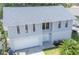 Exterior view of the house showcasing the yard, driveway, and front facade at 320 Crosswinds Dr, Palm Harbor, FL 34683