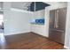 Bright kitchen features white cabinets, stainless steel appliances, granite counters, and hardwood floors at 320 Crosswinds Dr, Palm Harbor, FL 34683