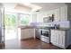 Modern kitchen featuring stainless steel appliances, granite countertops, and ample cabinet space at 320 Crosswinds Dr, Palm Harbor, FL 34683