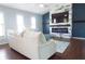 Comfortable living room features wood floors, a modern fireplace, and bright windows at 320 Crosswinds Dr, Palm Harbor, FL 34683