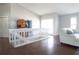 Bright interior living room with hardwood floors, white sofa, and staircase access at 320 Crosswinds Dr, Palm Harbor, FL 34683