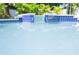 Close-up of the pool with tile and glass-block accents at 320 Crosswinds Dr, Palm Harbor, FL 34683