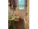 Vintage bathroom with unique green sink, toilet, and bathtub with linoleum tile flooring at 3210 W North B St, Tampa, FL 33609