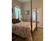 Bedroom featuring a four-poster bed with patterned bedding and glass paneled doors leading to another room at 3210 W North B St, Tampa, FL 33609