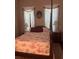 Charming bedroom showcasing a canopy bed with red patterned bedding and bright natural light from two windows at 3210 W North B St, Tampa, FL 33609