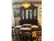 Elegant dining room boasting a large china cabinet, a round wooden table set for four, and decorative wallpaper at 3210 W North B St, Tampa, FL 33609