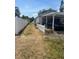 Driveway with white fence and carport offers privacy with ample space for parking vehicles and secure storage at 3210 W North B St, Tampa, FL 33609