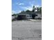 Exterior shot of a house with a carport, showing driveway and the side of the home with white trim at 3210 W North B St, Tampa, FL 33609
