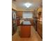 Well-lit kitchen featuring stainless steel appliances, an island with a dark countertop, and tile flooring at 3210 W North B St, Tampa, FL 33609