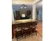 Cozy living area featuring a breakfast bar with granite countertops and barstools, overlooking a comfortable seating area at 3210 W North B St, Tampa, FL 33609