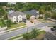 Aerial view showcasing two homes with manicured lawns, brick driveways, and well-maintained landscaping at 3603 Arbor Chase Dr, Palm Harbor, FL 34683