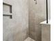 Modern bathroom with tiled shower, inset shelving, glass screen and white countertop at 3737 Nandina Cir, Sun City Center, FL 33573
