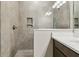 Modern bathroom featuring a tiled shower, built-in niche, and a vanity with a light countertop at 3737 Nandina Cir, Sun City Center, FL 33573