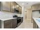 Well-equipped kitchen features stainless steel appliances, subway tile backsplash, and ample cabinet space at 3737 Nandina Cir, Sun City Center, FL 33573