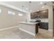 Modern kitchen boasts an island with seating, stainless steel appliances, and stylish pendant lighting at 3737 Nandina Cir, Sun City Center, FL 33573