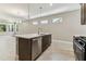 Open-concept kitchen design with island seating, stainless steel dishwasher, and a dining area at 3737 Nandina Cir, Sun City Center, FL 33573