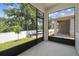 Enclosed patio featuring black aluminum framing and screens, perfect for enjoying the outdoors year-round at 3737 Nandina Cir, Sun City Center, FL 33573
