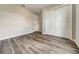 Bedroom features wood-look floors and a spacious closet at 37437 Laurel Hammock Dr, Zephyrhills, FL 33541