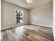Bright bedroom with modern wood floors and large window at 37437 Laurel Hammock Dr, Zephyrhills, FL 33541