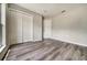 Bedroom with wood-look flooring, double closet doors, and neutral paint at 37437 Laurel Hammock Dr, Zephyrhills, FL 33541