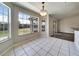 Bright dining area features tile floors, a view of the yard, and access to a sliding glass door at 37437 Laurel Hammock Dr, Zephyrhills, FL 33541