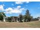 Traditional home featuring a well-manicured front lawn and classic architectural details at 37437 Laurel Hammock Dr, Zephyrhills, FL 33541