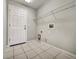 Laundry room featuring tile flooring and built-in shelving at 37437 Laurel Hammock Dr, Zephyrhills, FL 33541