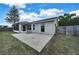 A concrete patio space connects to the screened in porch, extending the living space outdoors at 37437 Laurel Hammock Dr, Zephyrhills, FL 33541