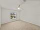 Bright, carpeted bedroom with a window providing natural light, offering a blank canvas for personalization at 37639 Newport Dr, Zephyrhills, FL 33542