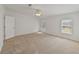 Sunlit bedroom with carpet floors, neutral walls, and ample natural light at 37639 Newport Dr, Zephyrhills, FL 33542