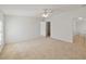 Spacious carpeted bedroom with neutral walls, ceiling fan, and walk-in closet at 37639 Newport Dr, Zephyrhills, FL 33542