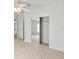 Bedroom featuring mirrored closet doors, carpeted flooring, and access to another room, offering convenience and space at 37639 Newport Dr, Zephyrhills, FL 33542