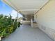 Covered carport boasting a concrete patio, a screened-in porch and beautiful, lush greenery at 37639 Newport Dr, Zephyrhills, FL 33542