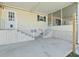 Carport with concrete patio and stairs leading to the entrance featuring a screened porch on a single story home at 37639 Newport Dr, Zephyrhills, FL 33542