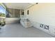 Carport featuring a screened-in porch, a concrete patio, and well-kept stairs leading to the entrance at 37639 Newport Dr, Zephyrhills, FL 33542