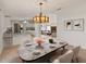 Elegant dining room with a stylish table setting and chandelier, perfect for gatherings and entertaining guests at 37639 Newport Dr, Zephyrhills, FL 33542