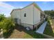 Ranch style home with a ramp, with vinyl siding, a well-maintained lawn, and mature trees at 37639 Newport Dr, Zephyrhills, FL 33542