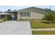 Inviting single-story home featuring neutral siding, a carport, and a meticulously kept front lawn at 37639 Newport Dr, Zephyrhills, FL 33542