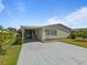Attractive single-story home boasting a covered carport, a screened porch, and blossoming landscaping at 37639 Newport Dr, Zephyrhills, FL 33542