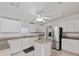 Bright kitchen with stainless steel refrigerator, center island, and neutral countertops at 37639 Newport Dr, Zephyrhills, FL 33542