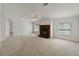 Spacious living room with natural light, neutral walls, and traditional fireplace at 37639 Newport Dr, Zephyrhills, FL 33542