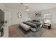 Stylishly furnished main bedroom with large bed, bench, and coordinating decor at 37639 Newport Dr, Zephyrhills, FL 33542